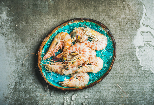 Raw uncooked tiger prawns on chipped ice, copy space - Stock Photo - Images