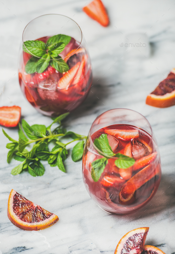 Fruit refreshing Sangria cocktails in glasses with ice and mint - Stock Photo - Images