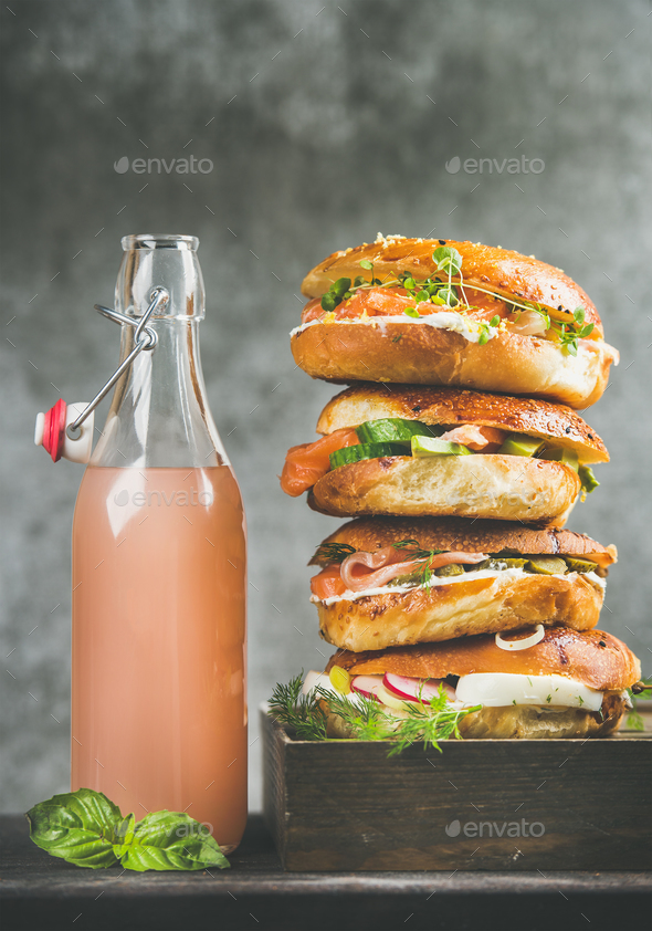 Heap of bagels with salmon, eggs, vegetables, capers, cream-cheese, lemonade - Stock Photo - Images