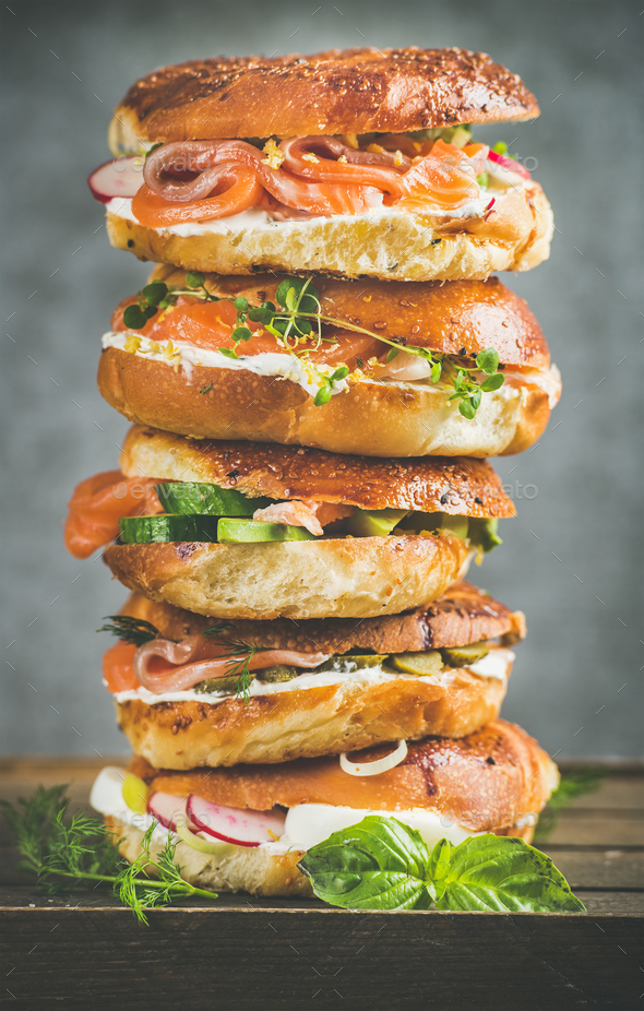 Heap of Bagels with salmon, eggs, vegetables, capers, cream-cheese, herbs - Stock Photo - Images