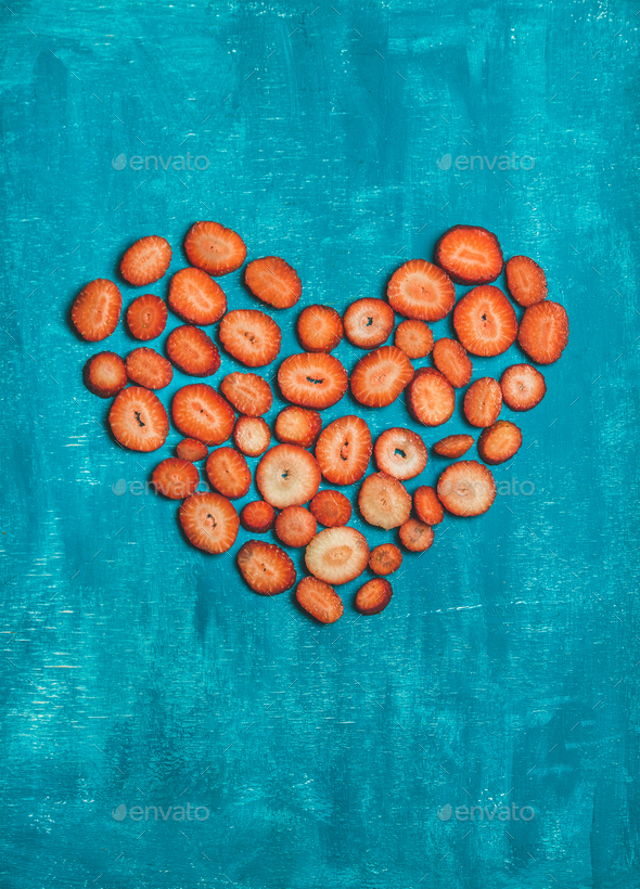 Pieces of fresh red strawberry placed in heart shape - Stock Photo - Images