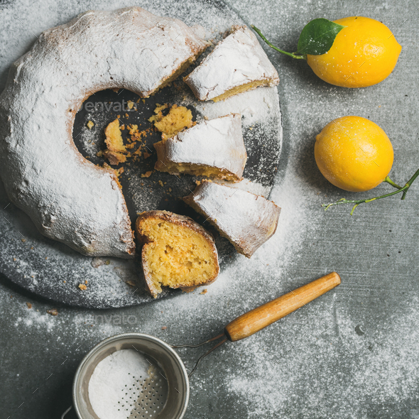 Homemade gluten-free lemon bundt cake over grey concrete background