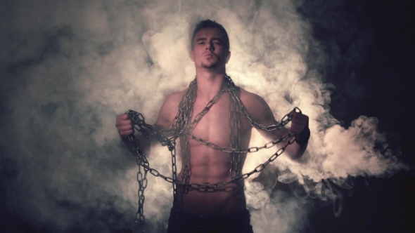 Man in Metal Chains in Smoke
