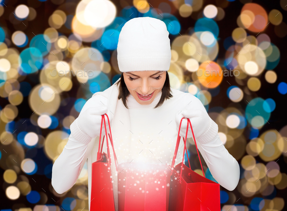 woman in winter hat with christmas shopping bags