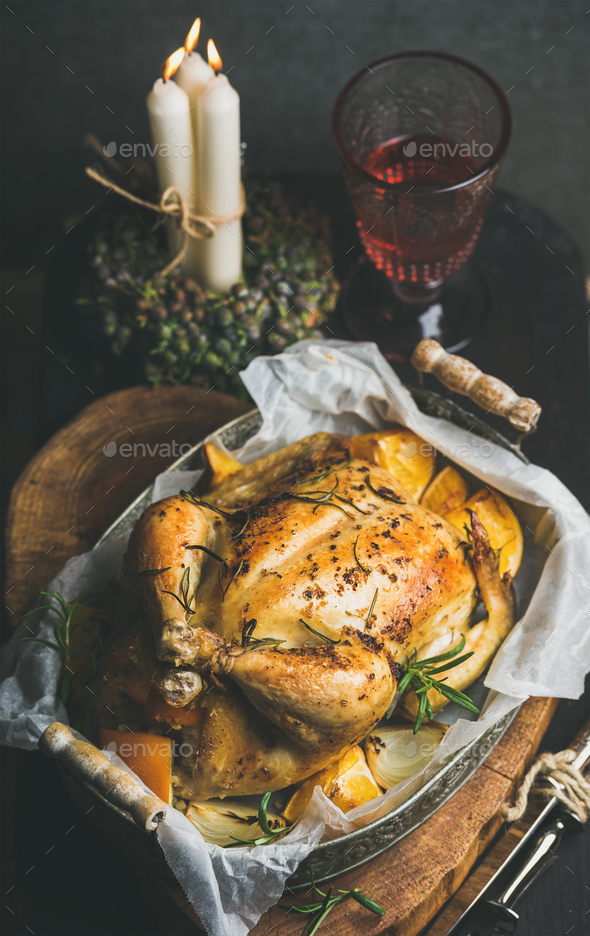 Christmas table set with oven roasted whole chicken and wine - Stock Photo - Images