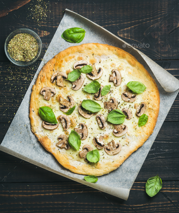 Homemade round mushroom pizza with basil and spices in glass - Stock Photo - Images
