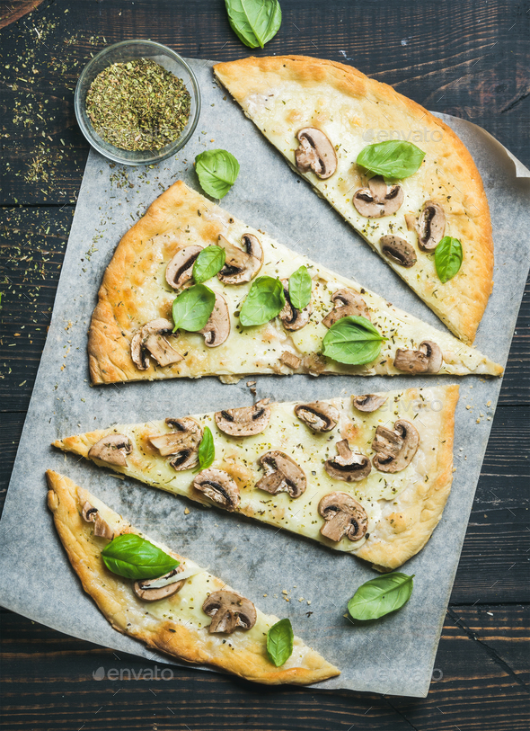 Homemade sliced mushroom pizza with basil and spices in glass - Stock Photo - Images