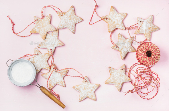 Christmas gingerbread star shaped cookies with sugar powder in sieve - Stock Photo - Images