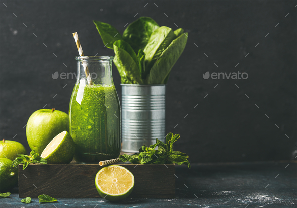 Green smoothie in glass bottle with fresh fruits, copy space - Stock Photo - Images