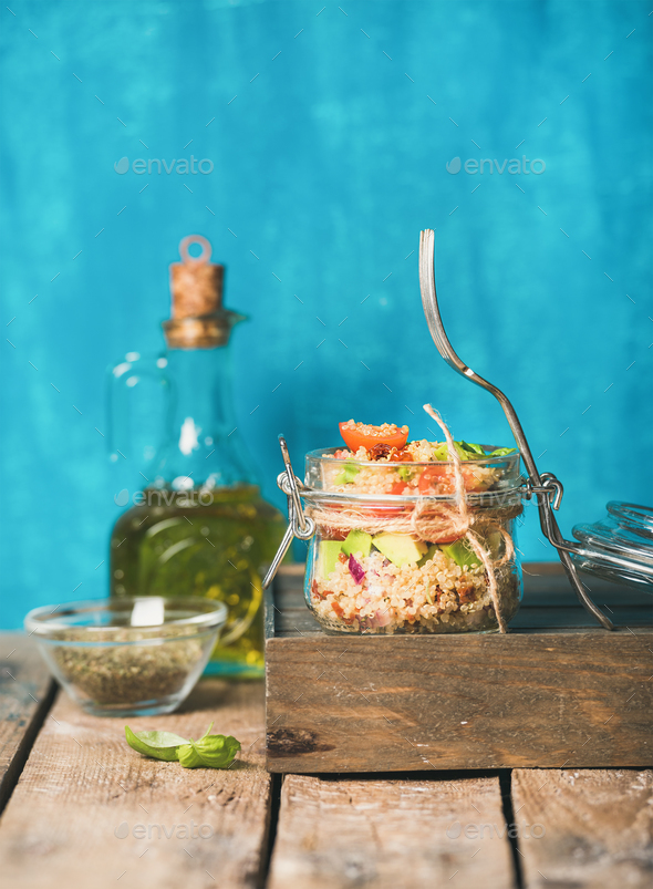Healthy homemade jar quinoa salad with tomatoes, avocado, fresh basil - Stock Photo - Images