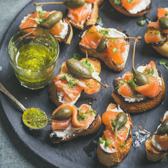 Close-up of salmon crostini with homemade pesto sauce - Stock Photo - Images