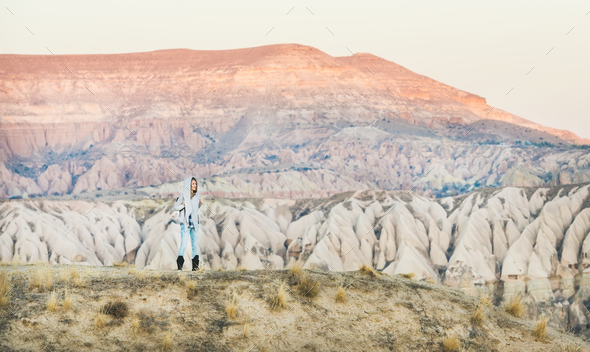 Young woman traveller hiking in mountains in Cappadocia, Central Turkey - Stock Photo - Images