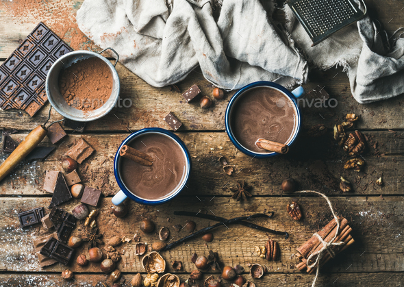 Hot chocolate with cinnamon sticks, anise, nuts and cocoa powder - Stock Photo - Images
