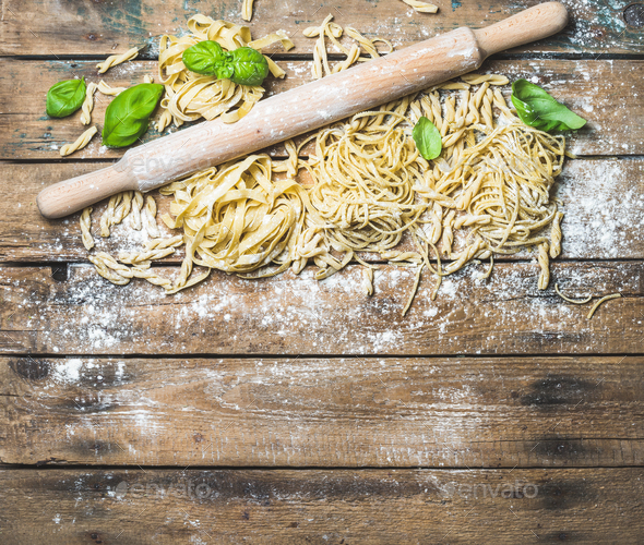 Various homemade fresh uncooked Italian pasta and plunger - Stock Photo - Images
