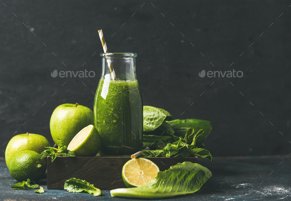 Smoothie with apple, romaine lettuce, lime, mint, dark blue background - Stock Photo - Images