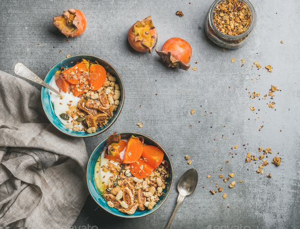 Healthy vegetarian breakfast in colorful bowls over grey concrete background - Stock Photo - Images
