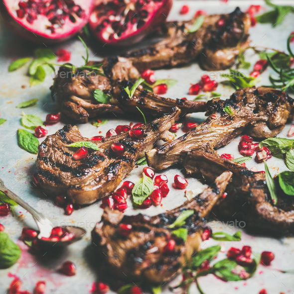 Grilled lamb ribs with pomegranate seeds, mint and rosemary - Stock Photo - Images