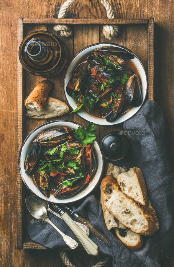 Flat-lay of Belgian boiled mussels in tomato sauce and beer - Stock Photo - Images