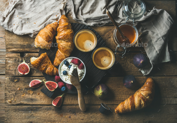 Breakfast with croissants, ricotta, figs, fresh berries, honey and espresso - Stock Photo - Images