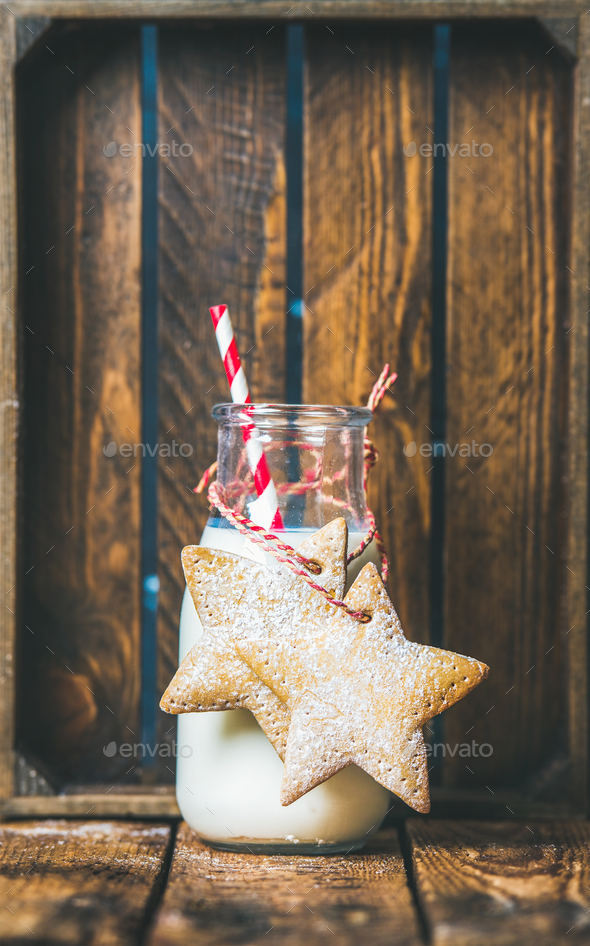 Bottle with milk and Christmas festive gingerbread star shaped cookies - Stock Photo - Images