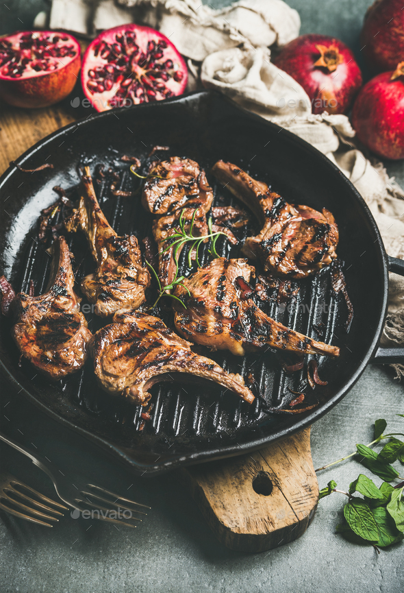 Grilled lamb meat chops served with fresh pomegranates and mint - Stock Photo - Images