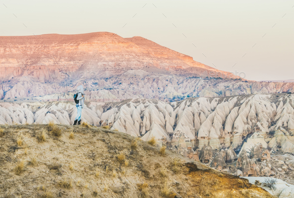 Young woman traveller hiking in mountains in Cappadocia, Turkey - Stock Photo - Images