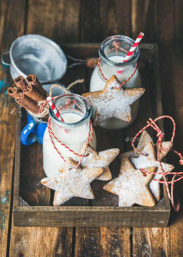 Bottles with milk for Santa and Christmas homemade gingerbread biscuits - Stock Photo - Images