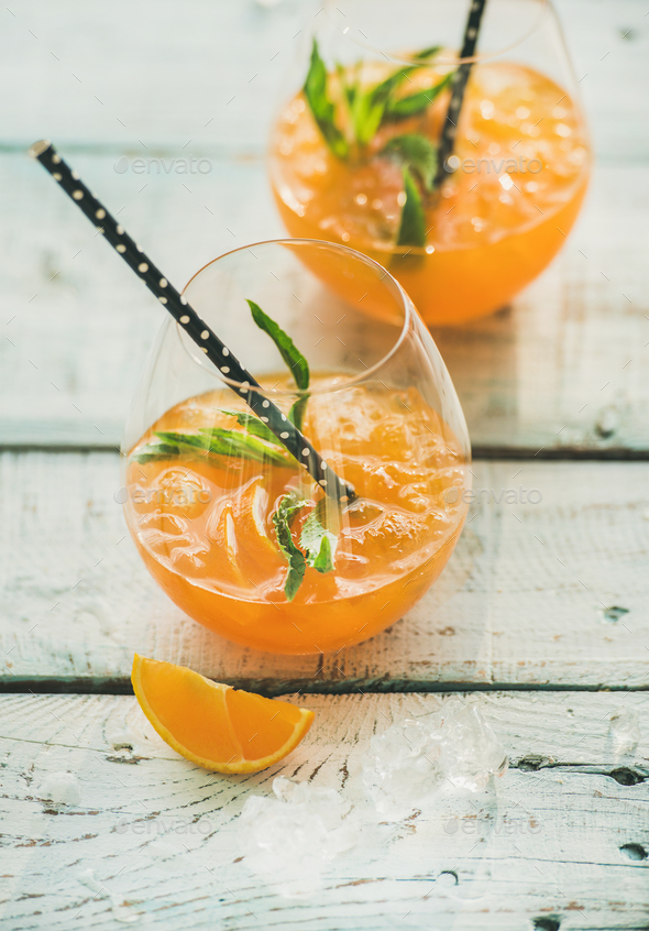 Refreshing cold alcoholic summer cocktail with orange in glasses - Stock Photo - Images