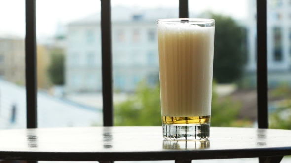 Glass of Beer on the Table on the Balcony