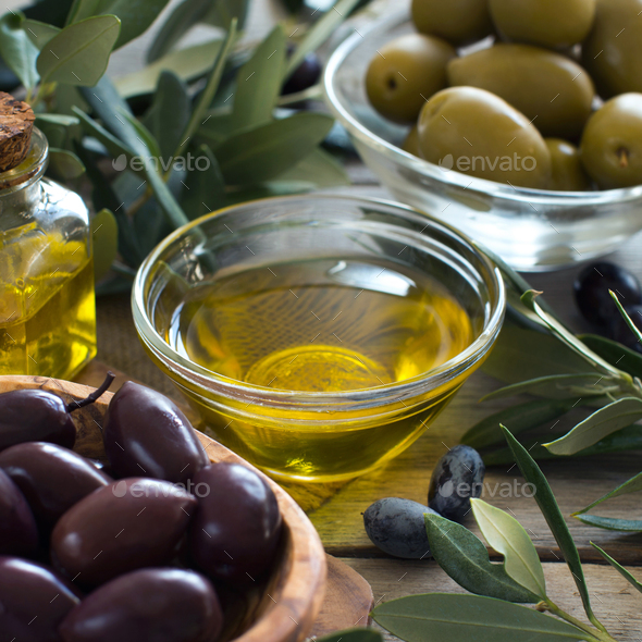 Olive oil and olives on wood background - Stock Photo - Images