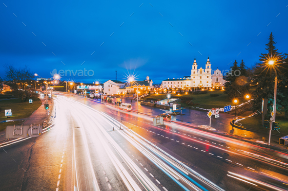Minsk, Belarus. Night Traffic On Illuminated Street And Cathedr - Stock Photo - Images