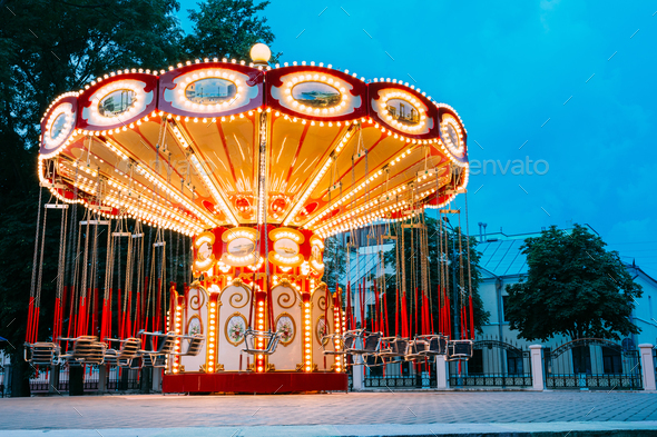 Brightly Illuminated Empty Carousel Merry-Go-Round. Nobody In Su - Stock Photo - Images