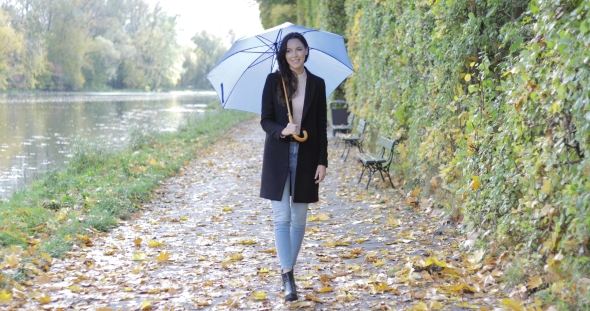 Woman with Umbrella Walking Near Pond alt