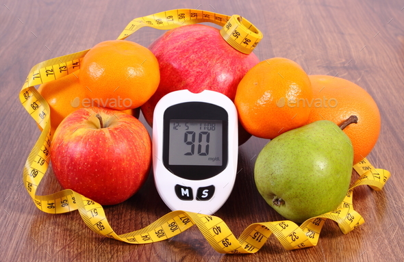 Glucose meter with tape measure and fresh fruits, diabetes, healthy nutrition and slimming concept