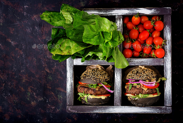 Black big sandwich - black hamburger with juicy beef burger - Stock Photo - Images