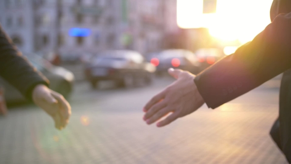 Two Business Man Handshake with Blurred City Background