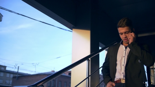 Young Handsome Businessman Talking on Mobile Phone in the City