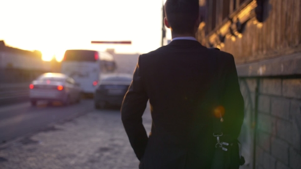 Attractive and Confident Businessman Walking Near Modern Office Building