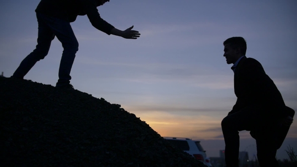 Businessman Silhouette Gived Hand for Pull Team To Peak Mountain Work Together