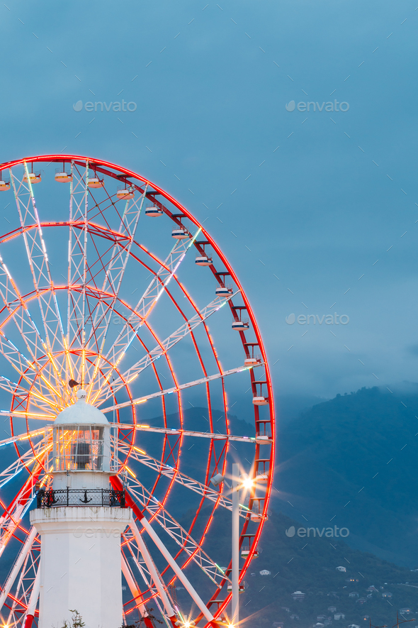 Batumi Georgia. Close View Of Ferris Wheel And Top Of White Ligh - Stock Photo - Images