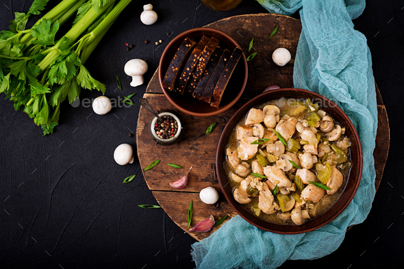 Delicate chicken fillet pieces with mushrooms and celery stewed in light beer. Flat lay. Top view - Stock Photo - Images