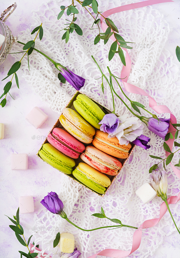 Colorful macaroons and marshmallows on a ligth background. Flat lay. Top view