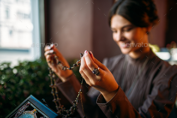 Woman's hands with old fashion style beads - Stock Photo - Images