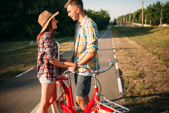 Love couple with vintage bicycle walking in park - Stock Photo - Images