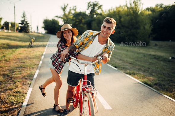 Love couple fun in summer park, vintage bicycle - Stock Photo - Images