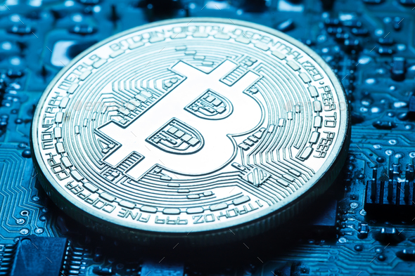 Virtual currency is the golden bitcoin on background of printed - Stock Photo - Images