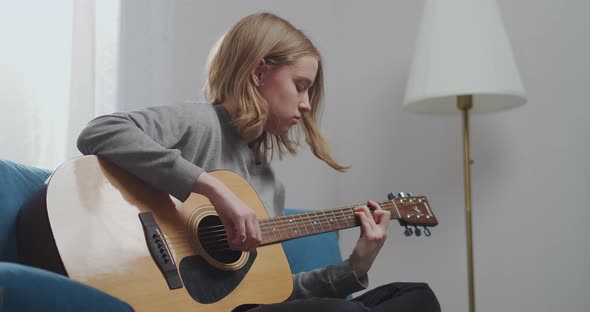 A Young Girl Beautifully Plays Funny Music on the Guitar alt
