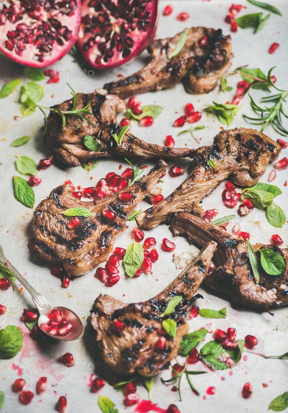 Grilled lamb ribs with pomegranate seeds, fresh mint and rosemary - Stock Photo - Images