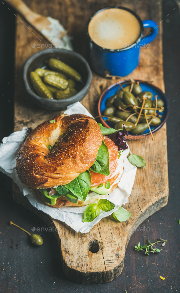 Breakfast with salmon, avocado, cream-cheese, basil bagel, espresso coffee, capers - Stock Photo - Images