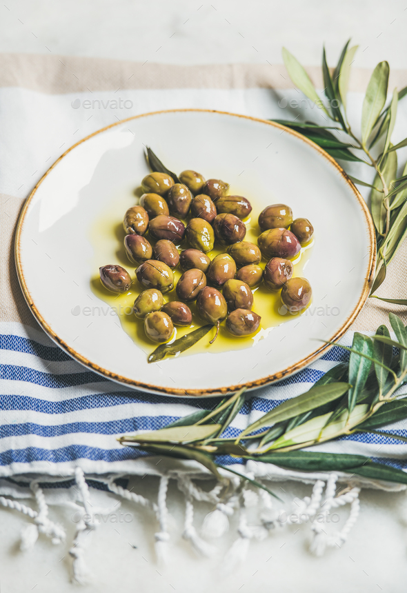Pickled green Mediterranean olives and olive tree branch - Stock Photo - Images